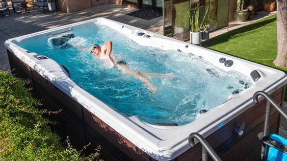 swimming in a swim spa in a garden